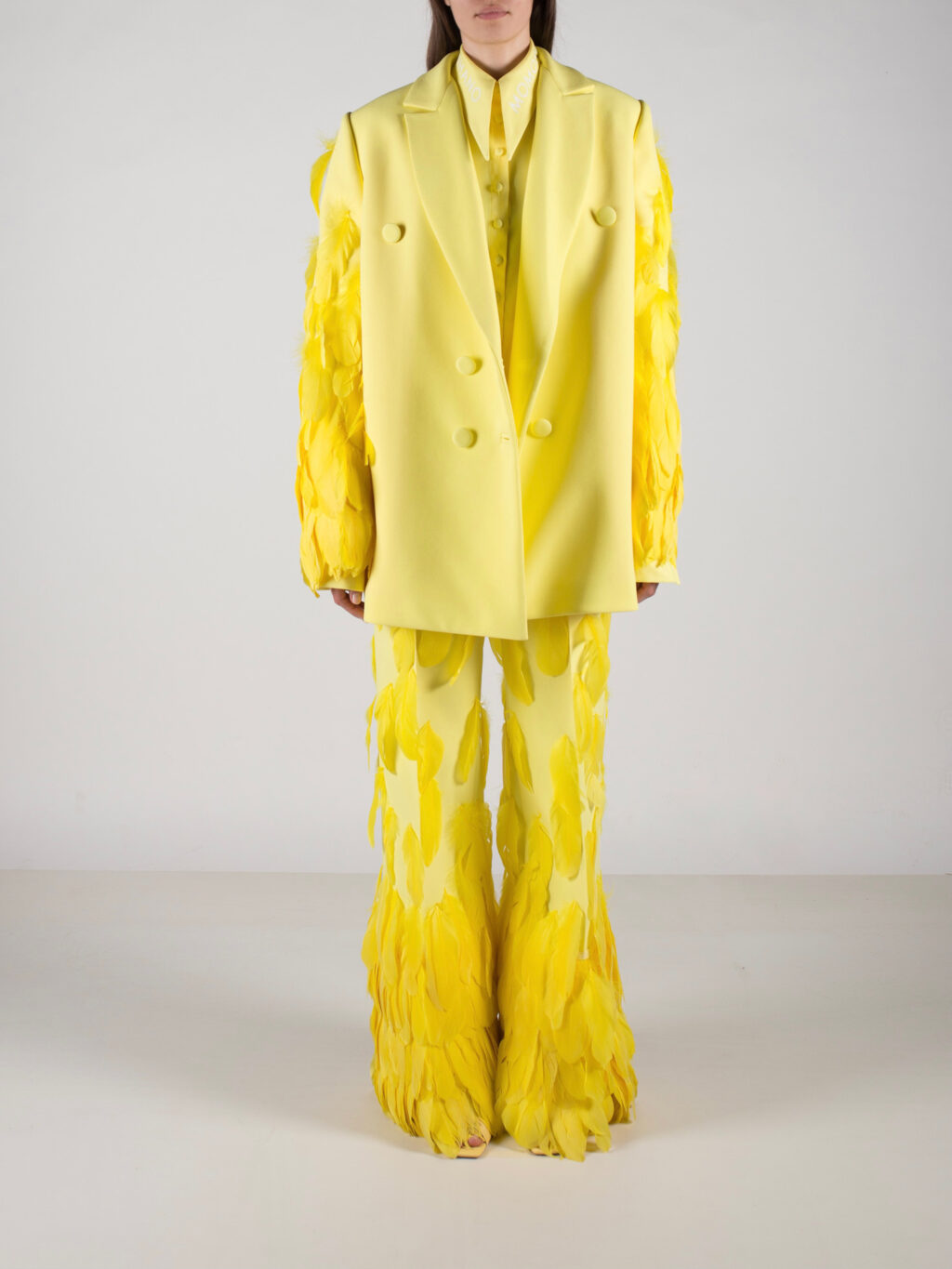 Yellow flared trousers with feathered details